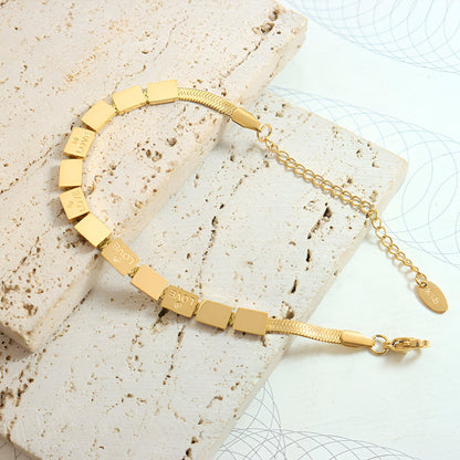 Pulsera Loïs “Love” de titanio chapada en oro de 18 quilates